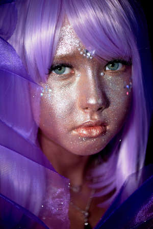 A girl with purple hair and glowing skin. An alien or a fairy with glowing skin.の写真素材