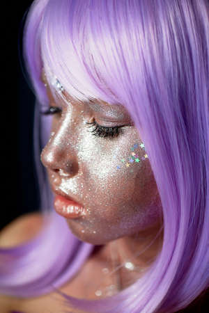 A girl with purple hair and glowing skin. An alien or a fairy with glowing skin.の写真素材