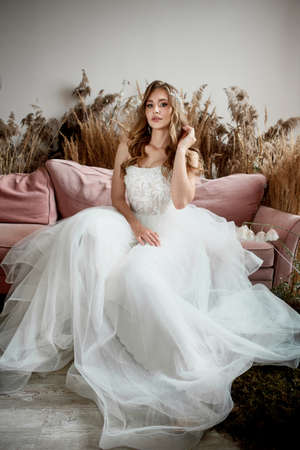 Charming young bride in luxurious wedding dress. Pretty girl in whiteの写真素材