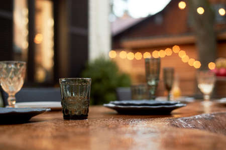 Covered table on the terrace. A table wet from the rain. The atmosphere in the restaurant.の写真素材