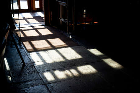 Shadows from the window on the concrete floor. Lock. The play of light and shadows. Mysticismの写真素材