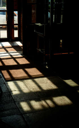 Shadows from the window on the concrete floor. Lock. The play of light and shadows. Mysticismの写真素材