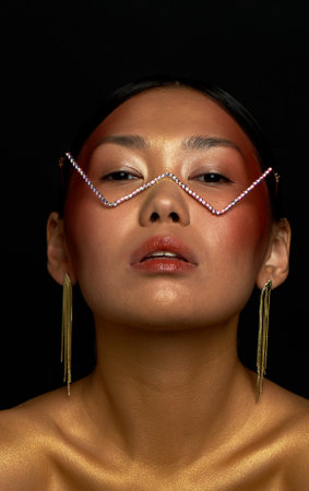 Beautiful Asian type girl in glasses with rhinestones. Optics, beauty salons.の写真素材