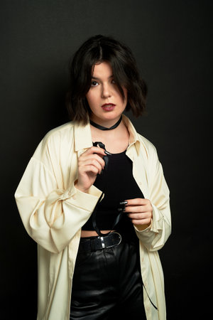 Brunette with a scarf on a dark background. Studio.の写真素材