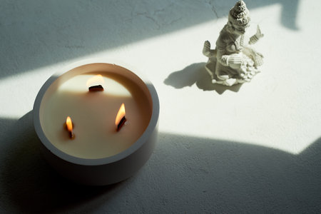 Goddess Lakshmi and a candle with three wooden wicks. Esotericism, religion. Abundanceの写真素材