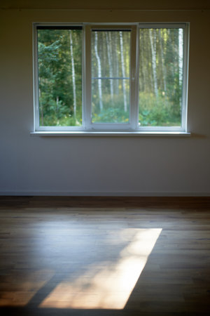 An empty room. Rays of light on the floor. Crossing. Yoga Room