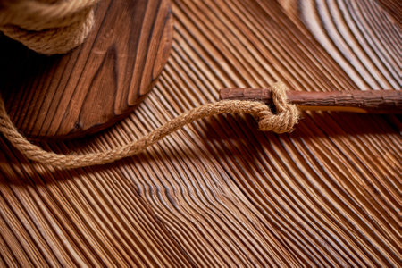 Wedding decoration in the Slavic style. A wooden reel with a strong rope and a pencil. An element of the table for notesの写真素材