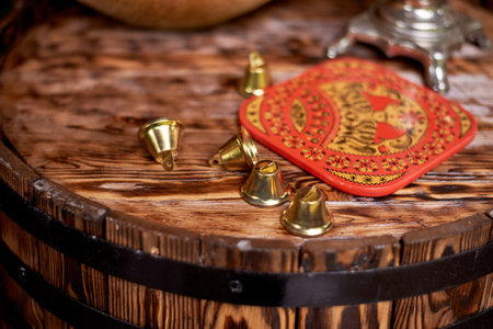 Wedding decoration in the Slavic style. Bells on the edge of a wooden barrelの写真素材