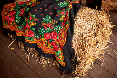 Wedding decoration in the Slavic style . Painted shawl on hay. Bright colors