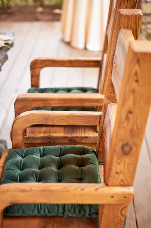 Wedding decoration in the Slavic style. Sturdy wooden thrones, chairs with green cushionsの写真素材