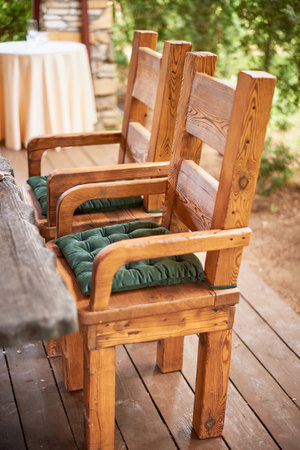 Wedding decoration in the Slavic style. Sturdy wooden thrones, chairs with green cushionsの写真素材