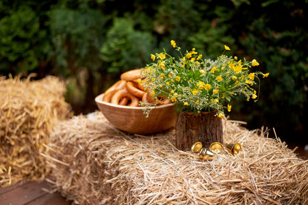 Wedding decoration in the Slavic style. Dried mushrooms and yellow flowers on haystacks. Halt, picnic and summer rest.の写真素材