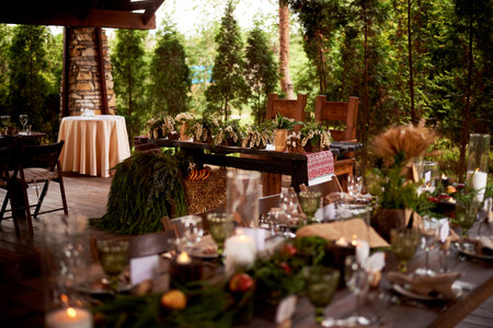 Banquet decoration in a simple rustic style with grass, greenery, simple objects and fabrics. Wedding table setting for guestsの写真素材