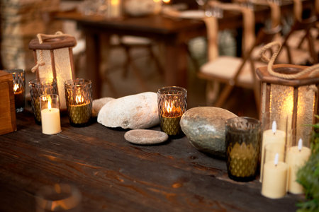Handmade wooden lanterns and large stones in the d cor of the wedding table in the style. Tree.の写真素材