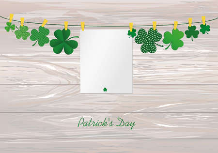Petals of clover with a picture hanging with paper blank on a rope with clothespins. St.Patrick 's Day. Vector illustration. Greeting card with empty space for text or advertising. On a wooden background.のイラスト素材