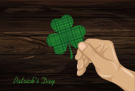 Hand holds ornate clover four-leaf. Celebration concept St. Patrick's Day. Greeting card. Vector illustration on a wooden background. Free space for your text and labels.のイラスト素材