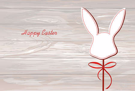 Paper easter bunny. Head of a rabbit on a stick with a bow and ribbon. Empty place for text or advertising. Greeting card or invitation for a holiday. Vector on wooden background.のイラスト素材