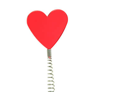 a red glass heart on a spring - novelty placemarkerの写真素材