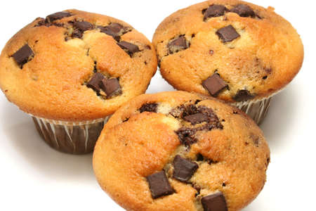close up of three chocolate chip muffins on a white backgroundの写真素材