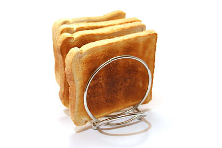 Four slices of toast on a stainless steel toast rackの写真素材