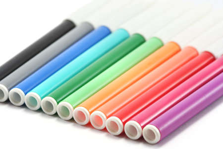 a row of childs colouring pens in rainbow coloursの写真素材