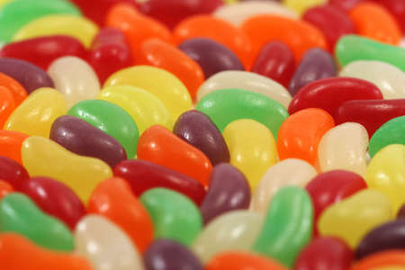 colourful fruit flavoured jellybeans taken from a low angle - shallow depth of field - ideal for use as a backgroundの写真素材