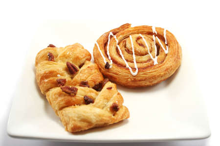 Cinnamon Swirl and maple/pecan slice, danish pastries on a plateの写真素材