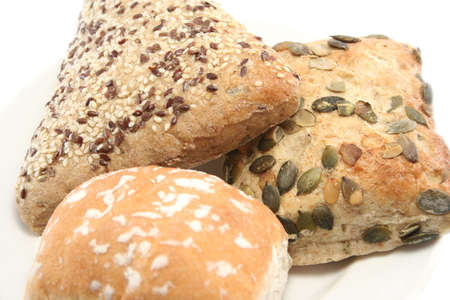 sesame seed, pumpkin seed and plain white rolls on a plate - closeupの写真素材