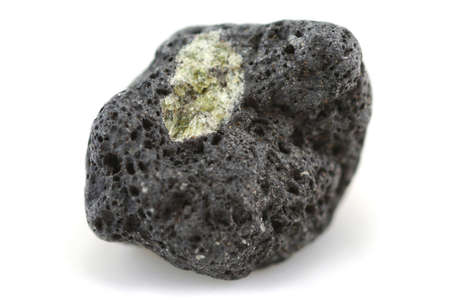 a small piece of lava rock with a greenish crystal inclusion - known as peridot. Handpicked from a beach on Lanzarote in the Canary Islandsの写真素材