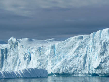 Part of a large iceberg off the coast of Greenland. Looks more like a cliff face.の写真素材