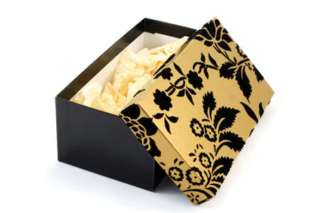 black and gold cardboard gift box, opened and showing tissue paper insideの写真素材
