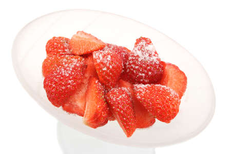 sliced/chopped strawberries with a sprinkling of sugar in a frosted glass bowlの写真素材