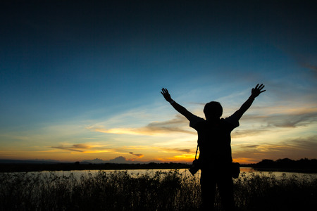strong confidence man open arms under the sunriseの写真素材