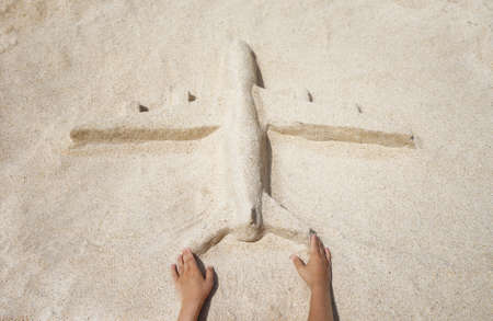 The plane of the sand on the beach girl handsの写真素材