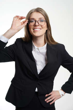 Eyewear glasses woman happy holding showing her new glasses smiling on white background. Beautiful young female model in her twenties.の写真素材