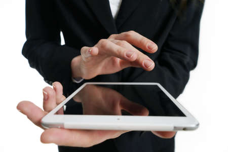 Tablet PC in the hands of a girl. Hands close-up leaf application on the tablet on a white background.の写真素材