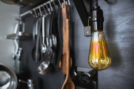 Edison lamp close-up on a background of black chalk board. The design of a modern kitchen in the apartment, loft-style and rustic.の写真素材
