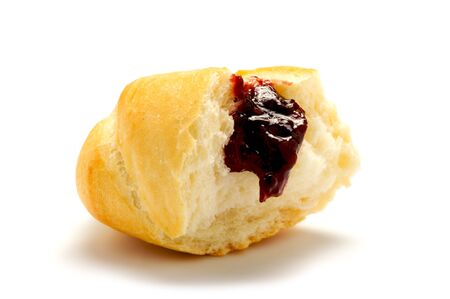 A piece of soft, fresh bun from white flour with jam isolated on a white background.の写真素材