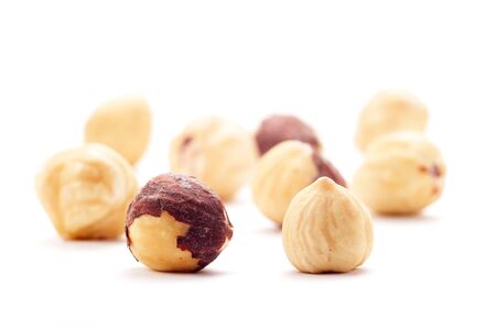 Several hazel nut, isolated on a white background. Background blurred.の写真素材