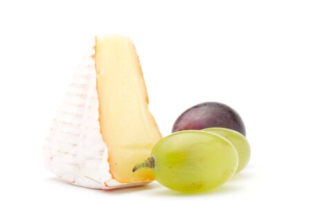 Piece of soft cheese and grapes. Isolated on a white background.の写真素材