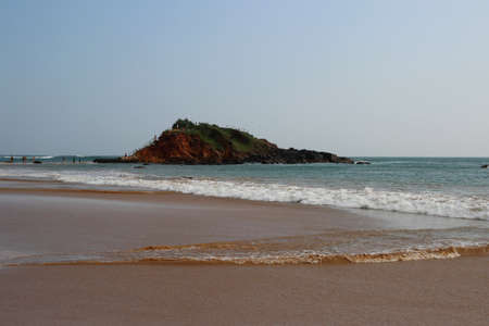 view of the hill in the middle of the sandy beachの写真素材