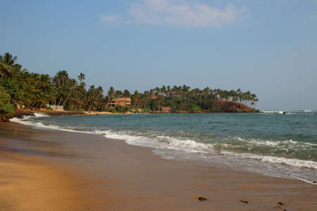 view of the tropical beach with waves breaking on a seashoreの写真素材