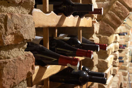 Bottles of wine stored in the cellarの写真素材