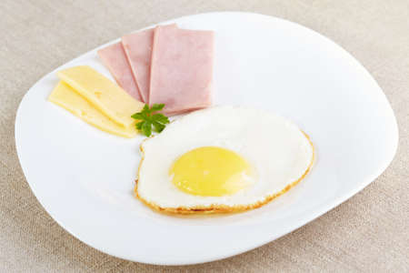Fried eggs with cheese and hamの写真素材