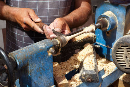 Greece, Crete. A master makes the spoon for honey in Ecopark on Lassithi Plateau
