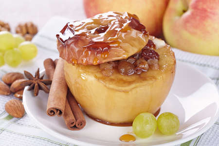 Apple baked with honey, nuts and raisinsの写真素材