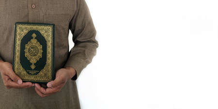 Man Holding and reading quran. Islamic Background