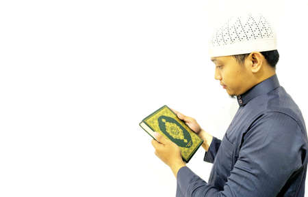 Man Holding and reading quran. Islamic Background