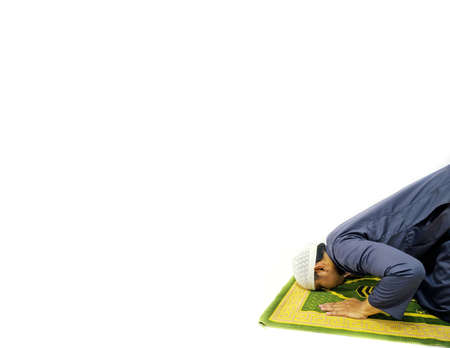 Photo of a man prostrating on a prayer rug ready for Ramadan.の写真素材