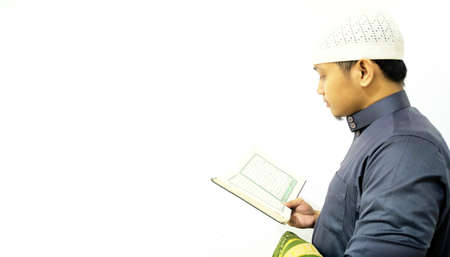 Man Holding and reading quran. Islamic Background
